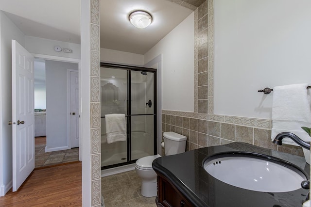 854 Kings Cv, Princeton, IL 61356 - bathroom featuring toilet, a shower stall, tile walls, and vanity