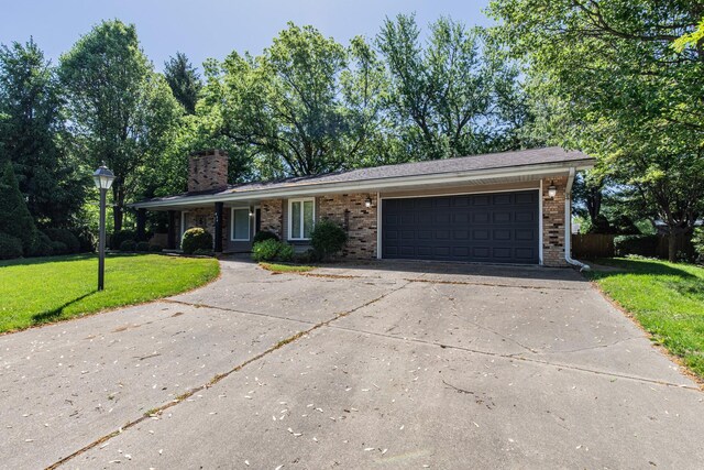 854 Kings Cv, Princeton, IL 61356 - ranch-style house featuring a front lawn, concrete driveway, an attached garage, brick siding, and a chimney