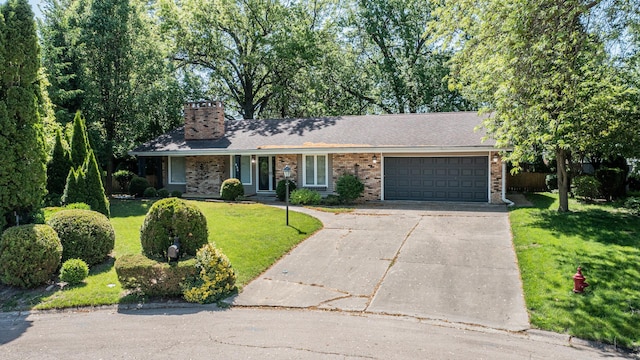 854 Kings Cv, Princeton, IL 61356 - ranch-style house with a chimney, concrete driveway, a garage, a front yard, and brick siding