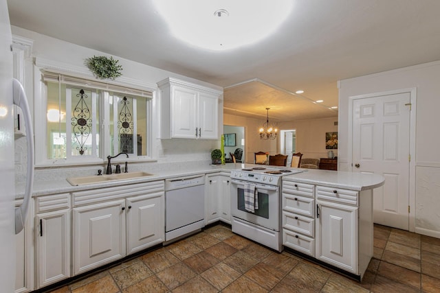 854 Kings Cv, Princeton, IL 61356 - kitchen featuring white appliances, a sink, a peninsula, a chandelier, and white cabinets
