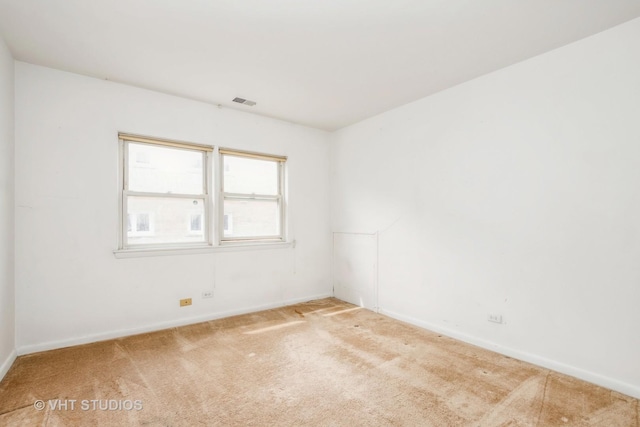 unfurnished room featuring baseboards, carpet, and visible vents