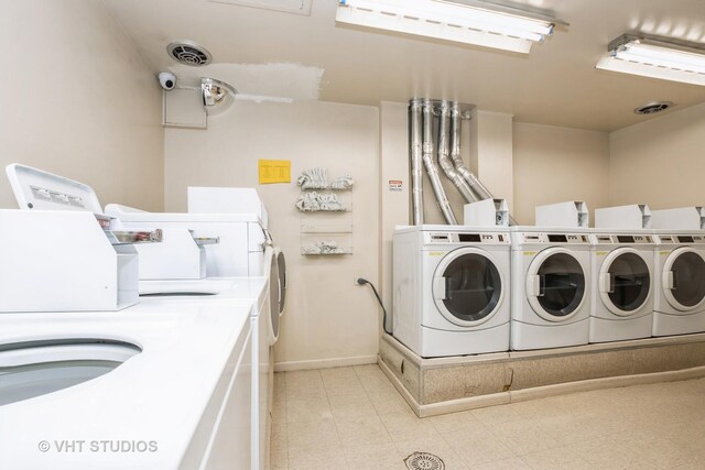 common laundry area featuring separate washer and dryer, baseboards, and visible vents