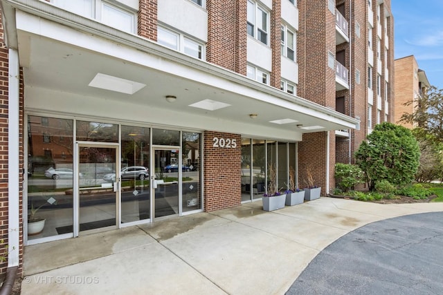 property entrance featuring brick siding