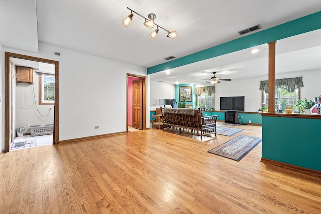 living room with plenty of natural light, light wood finished floors, and visible vents