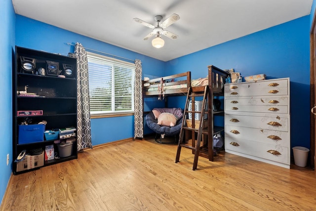 bedroom with baseboards, a ceiling fan, and wood finished floors