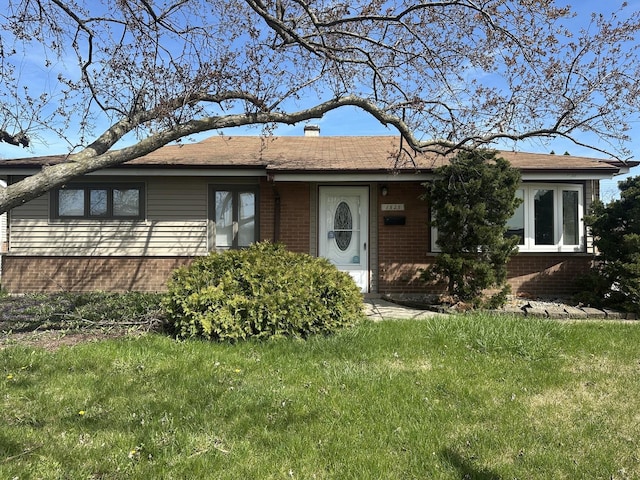1525 Gordon Ave, Calumet City, IL 60409 - ranch-style home with a shingled roof, a front lawn, a chimney, and brick siding