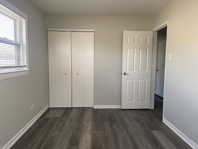 1525 Gordon Ave, Calumet City, IL 60409 - unfurnished bedroom featuring baseboards, a closet, and dark wood-style flooring