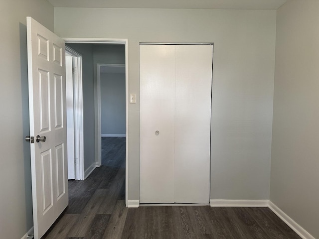 1525 Gordon Ave, Calumet City, IL 60409 - unfurnished bedroom featuring baseboards, dark wood-style floors, and a closet