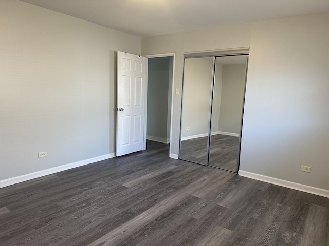 1525 Gordon Ave, Calumet City, IL 60409 - unfurnished bedroom featuring baseboards, dark wood-type flooring, and a closet