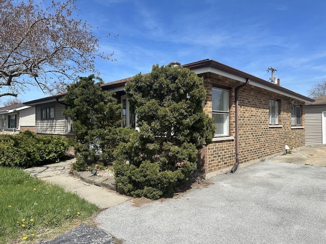 1525 Gordon Ave, Calumet City, IL 60409 - view of property exterior featuring brick siding, a garage, and aphalt driveway