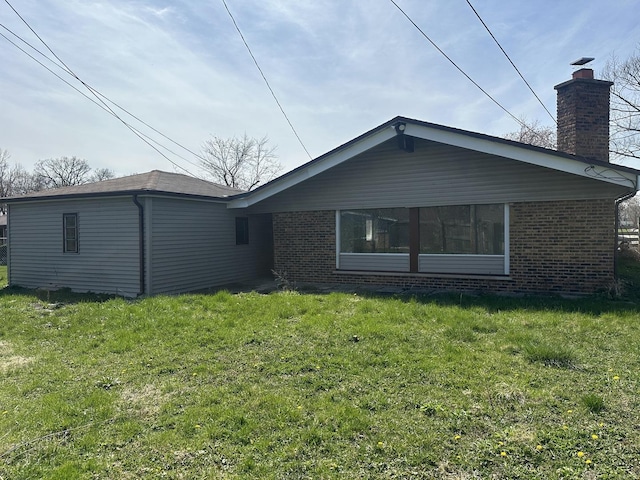 1525 Gordon Ave, Calumet City, IL 60409 - rear view of house with a lawn, brick siding, and a chimney