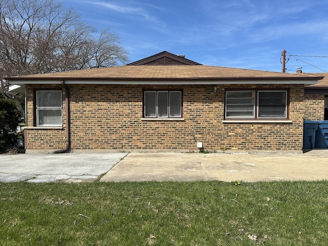 1525 Gordon Ave, Calumet City, IL 60409 - view of side of property with a lawn, brick siding, and a patio
