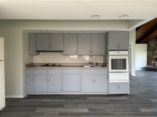 1525 Gordon Ave, Calumet City, IL 60409 - kitchen with a sink, white appliances, a warming drawer, backsplash, and gray cabinetry