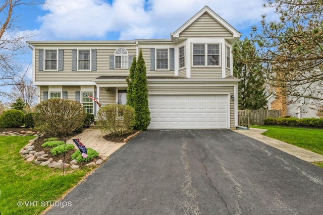2107 Lawson Blvd, Gurnee, IL 60031 - view of front of home featuring an attached garage, aphalt driveway, and fence
