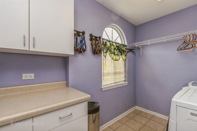 2107 Lawson Blvd, Gurnee, IL 60031 - washroom featuring washer / dryer, baseboards, light tile patterned flooring, and cabinet space