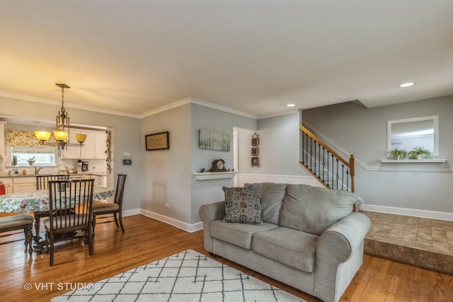 2107 Lawson Blvd, Gurnee, IL 60031 - living room with crown molding, baseboards, an inviting chandelier, and light wood-style floors