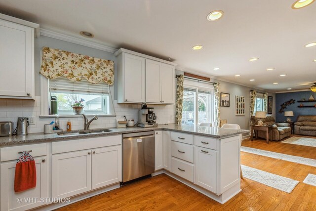 2107 Lawson Blvd, Gurnee, IL 60031 - kitchen with white cabinets, a sink, dishwasher, a peninsula, and ornamental molding