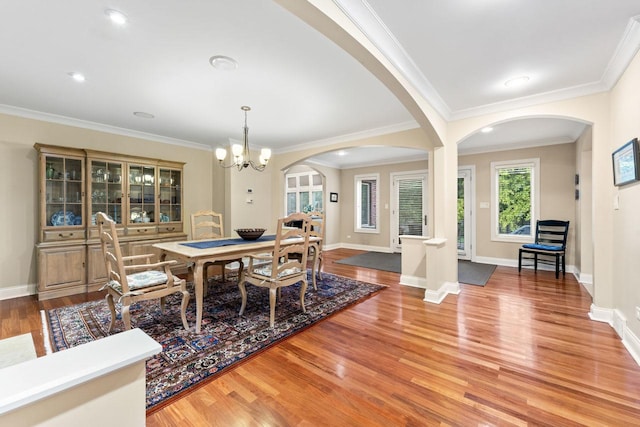860 Kenton Rd, Deerfield, IL 60015 - dining room with arched walkways, light wood-type flooring, a chandelier, and ornamental molding