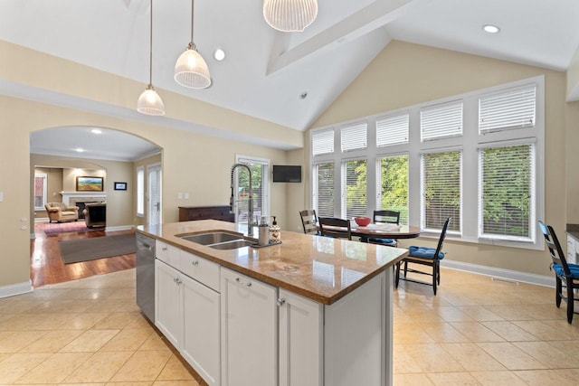 860 Kenton Rd, Deerfield, IL 60015 - kitchen featuring arched walkways, stainless steel dishwasher, decorative light fixtures, white cabinets, and light tile patterned floors