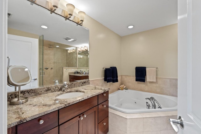 860 Kenton Rd, Deerfield, IL 60015 - full bath featuring a stall shower, a jetted tub, vanity, and recessed lighting