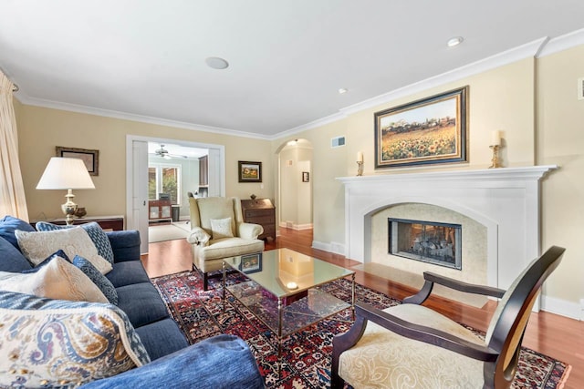 860 Kenton Rd, Deerfield, IL 60015 - living room with arched walkways, wood finished floors, ornamental molding, a fireplace, and ceiling fan