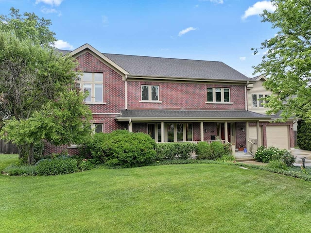 860 Kenton Rd, Deerfield, IL 60015 - view of front of home with covered porch, a front lawn, a garage, and brick siding