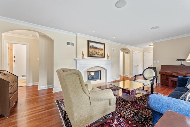 860 Kenton Rd, Deerfield, IL 60015 - living room with arched walkways, wood finished floors, crown molding, and a premium fireplace