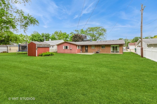 14937 Highland Ave, Orland Park, IL 60462 - rear view of property with a shed, a fenced backyard, a patio area, and a trampoline