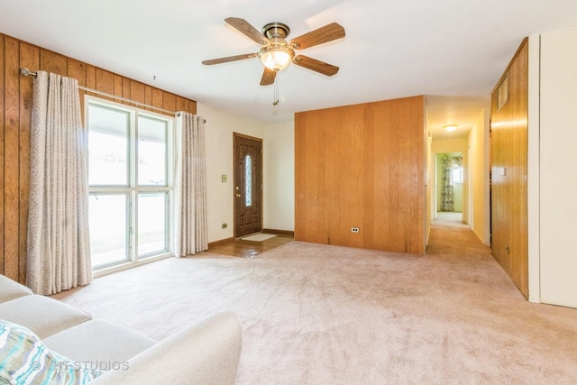 14937 Highland Ave, Orland Park, IL 60462 - living area with light carpet, a ceiling fan, and wooden walls