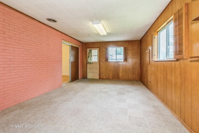 14937 Highland Ave, Orland Park, IL 60462 - unfurnished room featuring brick wall, light colored carpet, and wood walls