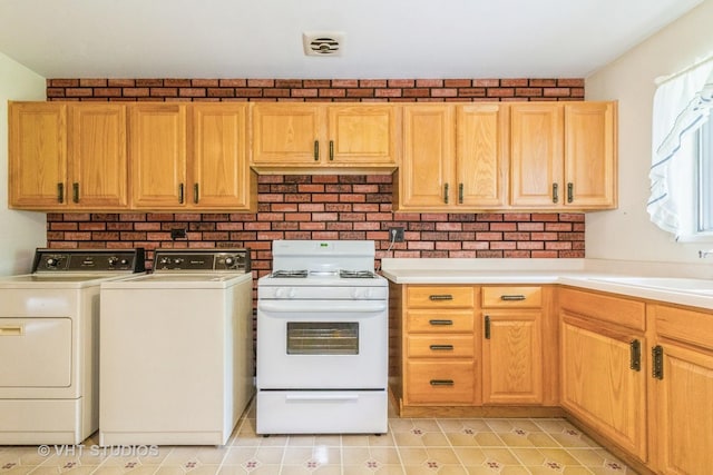 14937 Highland Ave, Orland Park, IL 60462 - kitchen featuring gas range gas stove, washing machine and dryer, light countertops, and light tile patterned flooring
