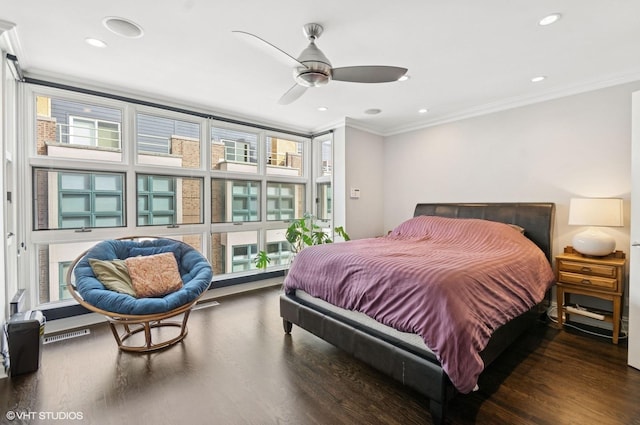 bedroom with recessed lighting, multiple windows, wood finished floors, and ornamental molding