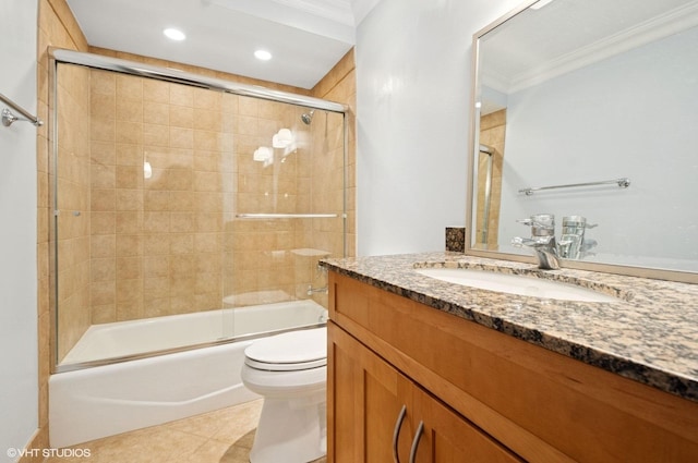 bathroom featuring combined bath / shower with glass door, crown molding, vanity, and toilet
