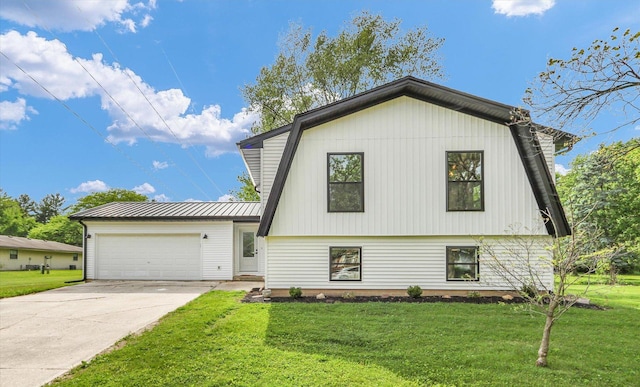 1801 Cindy Lynn St, Urbana, IL 61802 - view of front of property with an attached garage, a front yard, driveway, and metal roof