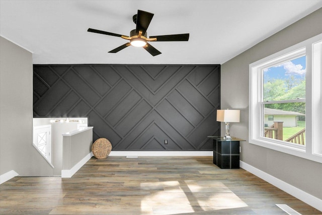 1801 Cindy Lynn St, Urbana, IL 61802 - interior space with baseboards, ceiling fan, wood finished floors, an accent wall, and a decorative wall