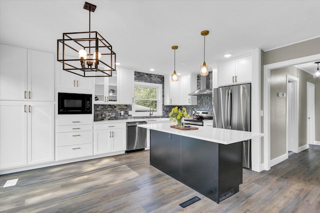1801 Cindy Lynn St, Urbana, IL 61802 - kitchen featuring appliances with stainless steel finishes, wall chimney exhaust hood, white cabinets, tasteful backsplash, and recessed lighting