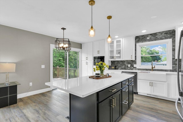 1801 Cindy Lynn St, Urbana, IL 61802 - kitchen featuring dishwasher, white cabinetry, light countertops, wood finished floors, and recessed lighting