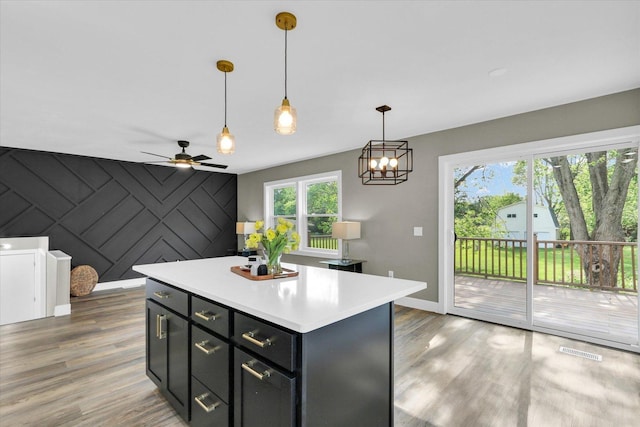1801 Cindy Lynn St, Urbana, IL 61802 - kitchen featuring baseboards, light wood-style flooring, light countertops, and an accent wall
