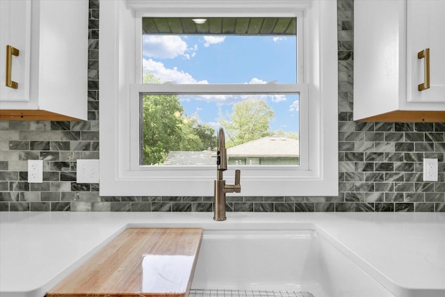 1801 Cindy Lynn St, Urbana, IL 61802 - kitchen view of white cabinets, decorative backsplash, and light countertops