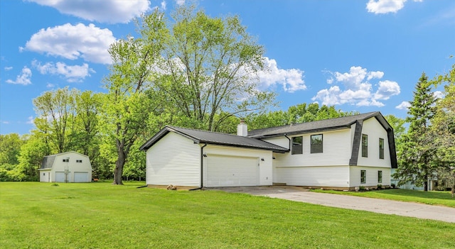 1801 Cindy Lynn St, Urbana, IL 61802 - view of front of property with an outbuilding, a front yard, concrete driveway, and a garage