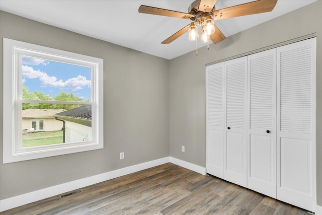 1801 Cindy Lynn St, Urbana, IL 61802 - unfurnished bedroom with baseboards, wood finished floors, a closet, and ceiling fan