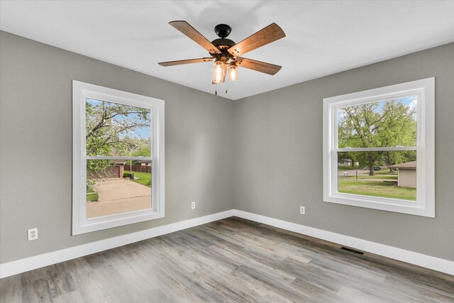1801 Cindy Lynn St, Urbana, IL 61802 - spare room featuring wood finished floors, baseboards, and ceiling fan