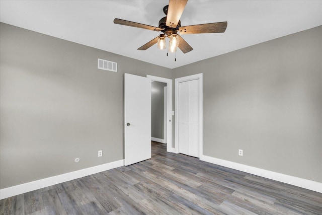 1801 Cindy Lynn St, Urbana, IL 61802 - unfurnished bedroom with wood finished floors, baseboards, a closet, and a ceiling fan