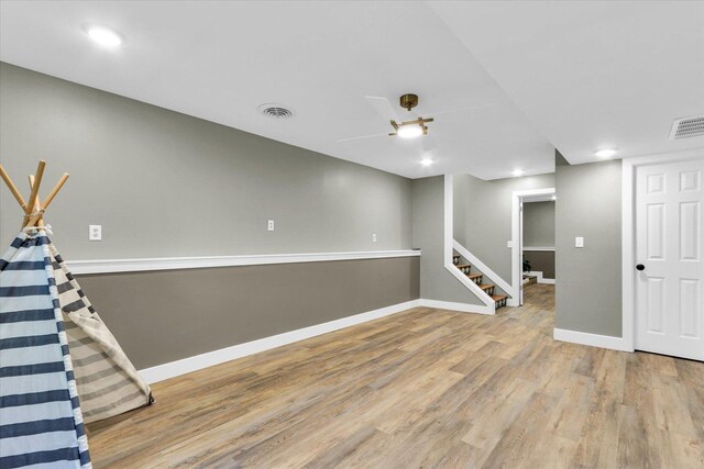 1801 Cindy Lynn St, Urbana, IL 61802 - finished below grade area with wood finished floors, baseboards, stairway, and a ceiling fan