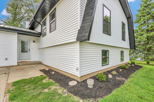 1801 Cindy Lynn St, Urbana, IL 61802 - view of property exterior featuring a chimney, metal roof, a lawn, and a standing seam roof