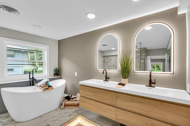 1801 Cindy Lynn St, Urbana, IL 61802 - bathroom featuring marble look tile flooring, a walk in shower, double vanity, a freestanding bath, and recessed lighting
