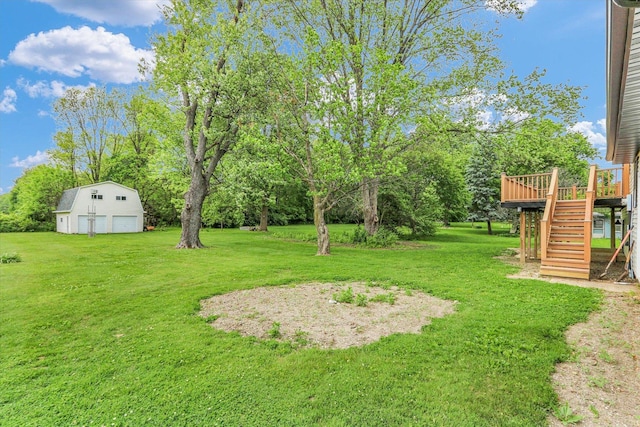 1801 Cindy Lynn St, Urbana, IL 61802 - view of grassy yard featuring stairway, an outbuilding, a wooden deck, a detached garage, and view of wooded area