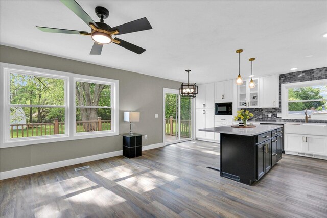 1801 Cindy Lynn St, Urbana, IL 61802 - kitchen featuring white cabinets, baseboards, a sink, black microwave, and recessed lighting