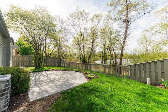 view of yard featuring a fenced backyard, a patio area, and central AC