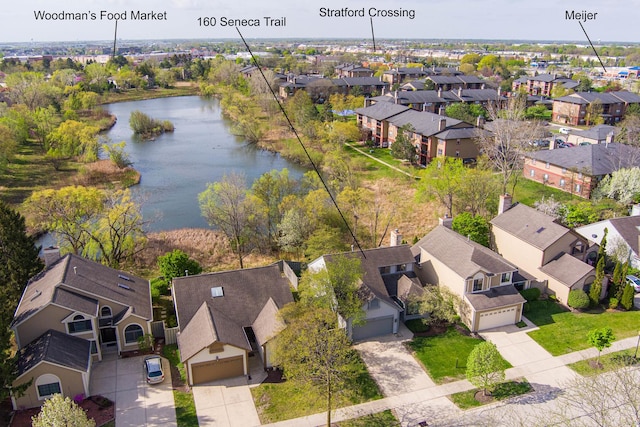 drone / aerial view featuring a water view and a residential view